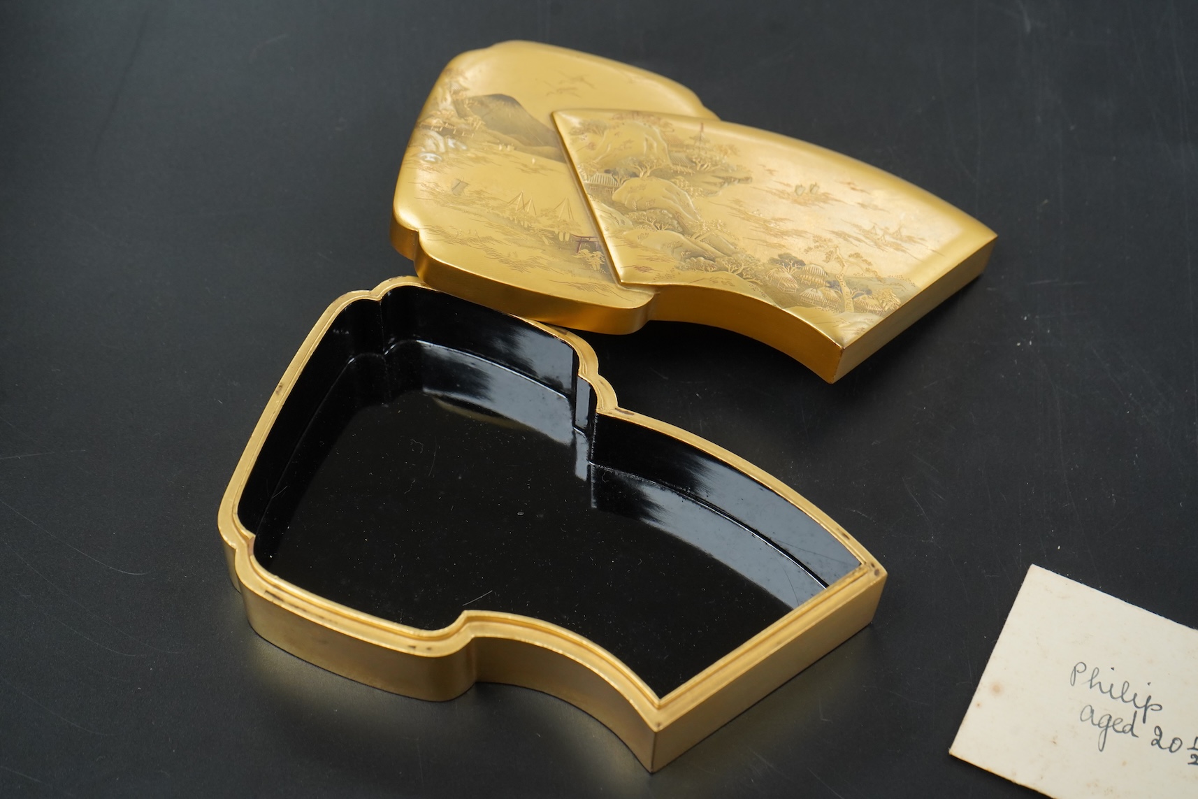A Japanese gilt lacquer box depicting a mountainous landscape, 13.5cm wide